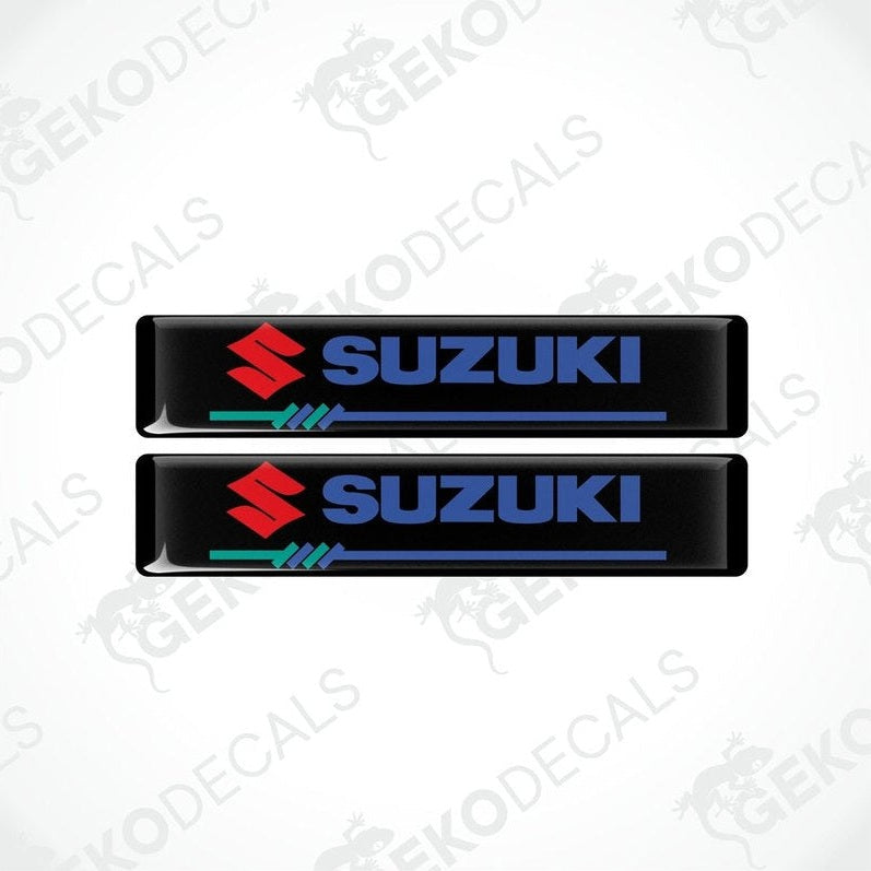Two black vinyl stickers with the SUZUKI brand logo in blue and red.