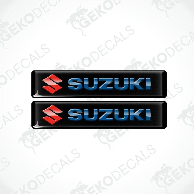 Two black vinyl stickers with the SUZUKI brand logo in blue and red.