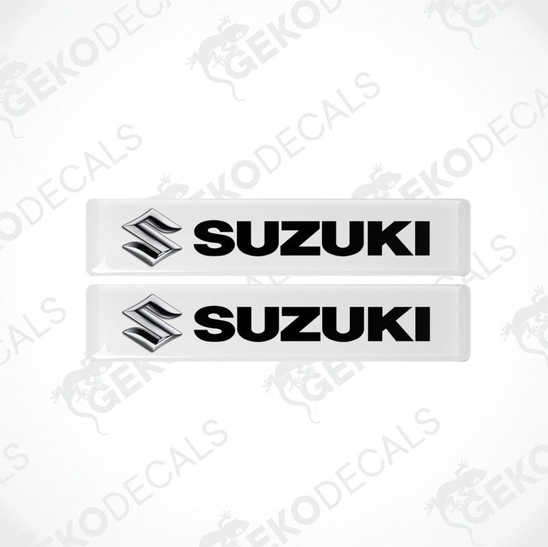 Two withe vinyl stickers with the text 'SUZUKI' and the Suzuki logo.