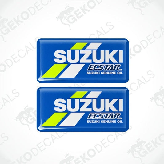 Two blue vinyl stickers with the text 'SUZUKI ECSTAR GENUINE OIL' and a logo depicting a stylized tire and the Suzuki logo in white and green.