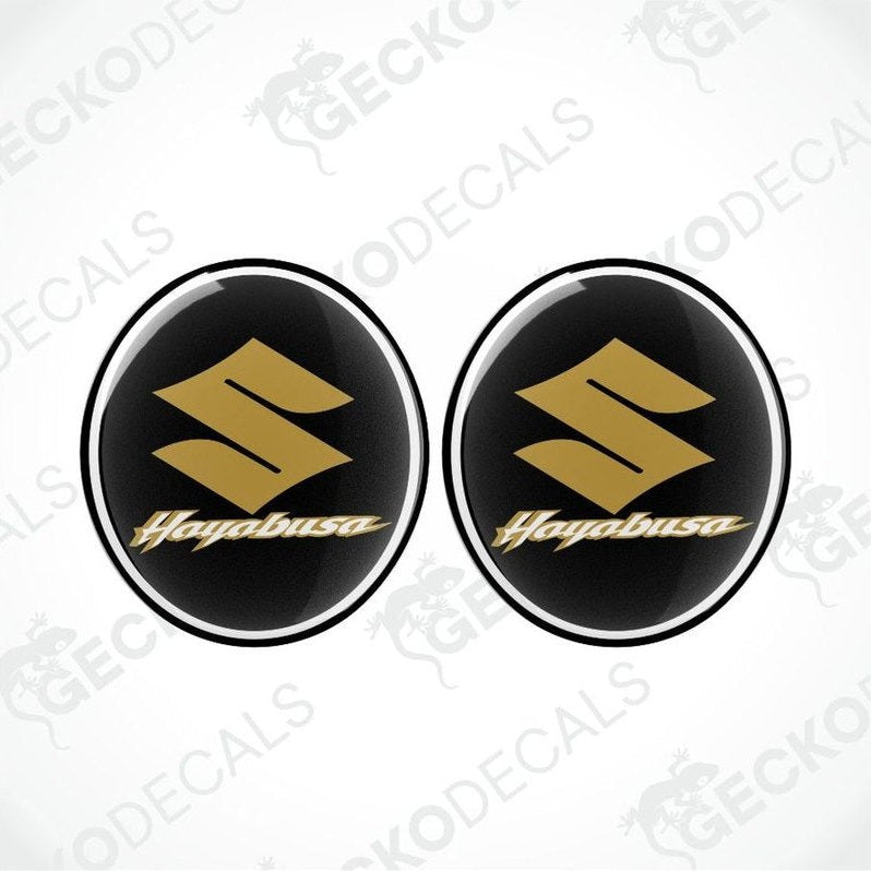 Two gold 'Hogabusa' logos on black circular backgrounds with a white border.