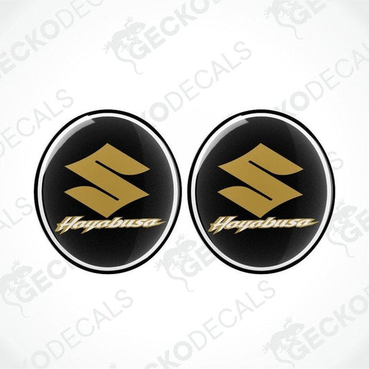 Two gold 'Hogabusa' logos on black circular backgrounds with a white border.