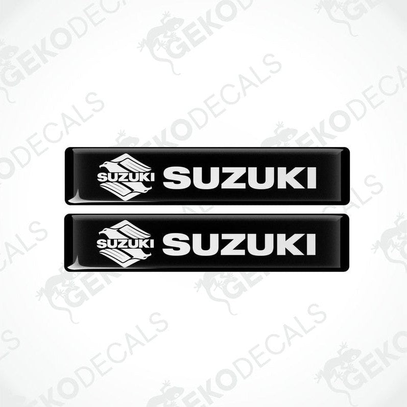 Two black vinyl stickers with the word 'SUZUKI' printed on them.