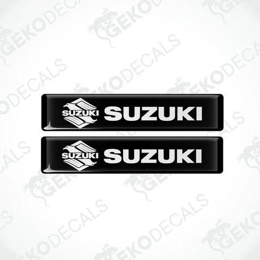 Two black vinyl stickers with the word 'SUZUKI' printed on them.
