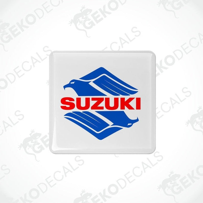 White square stickers with the SUZUKI brand logo in blue and red.
