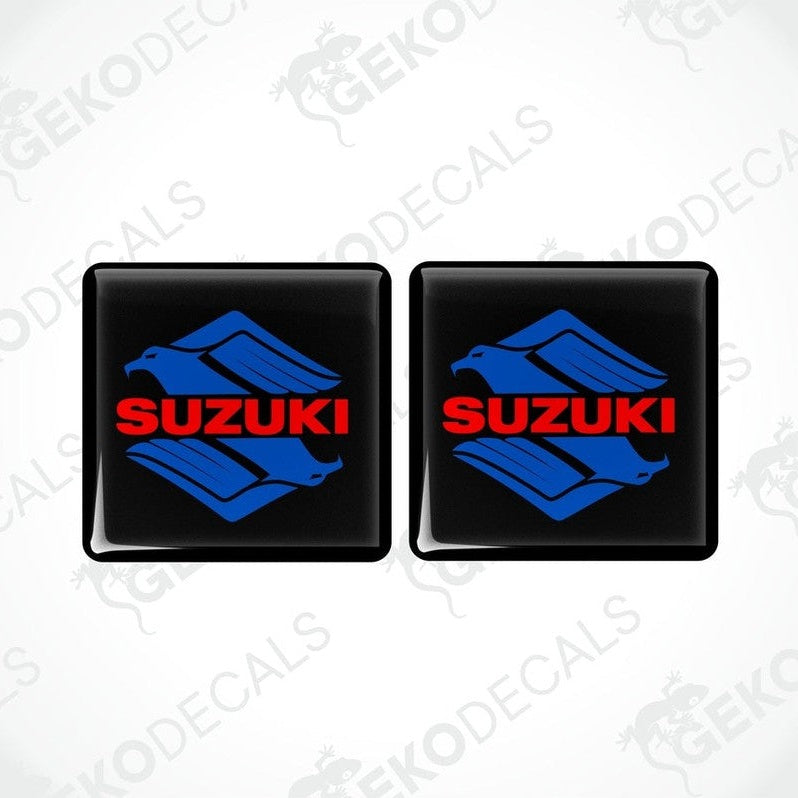 Two black square stickers with the SUZUKI brand logo in blue and red.