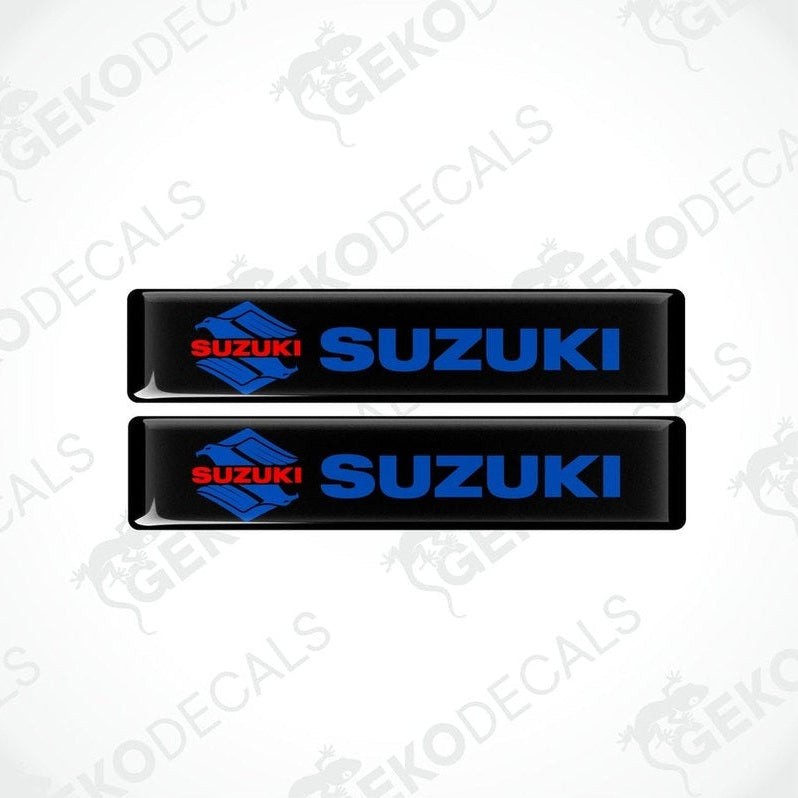 Two black vinyl stickers with the SUZUKI brand logo in blue and red.