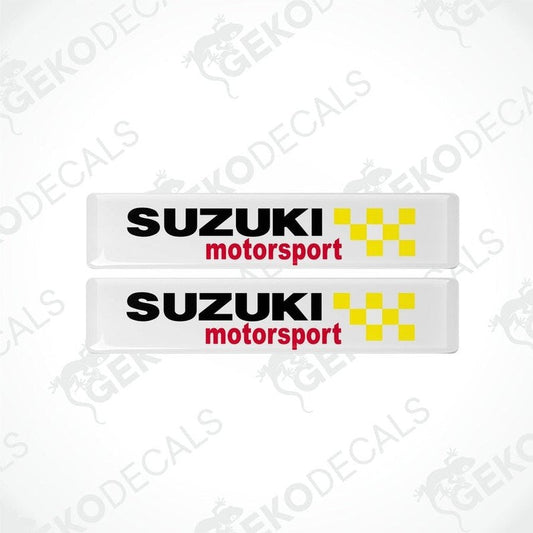 Two white vinyl stickers with the SUZUKI MOTORSPORT logo in black and red.