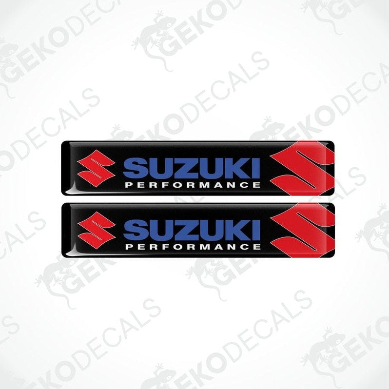 Two rectangular black vinyl decals with the 'Suzuki Performance' logo in red and white.