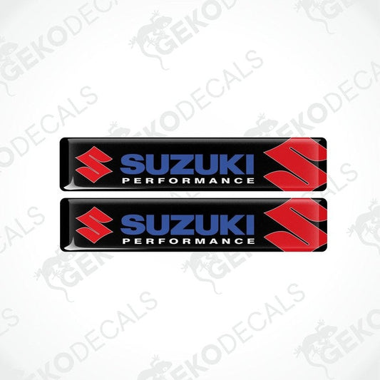 Two rectangular black vinyl decals with the 'Suzuki Performance' logo in red and white.