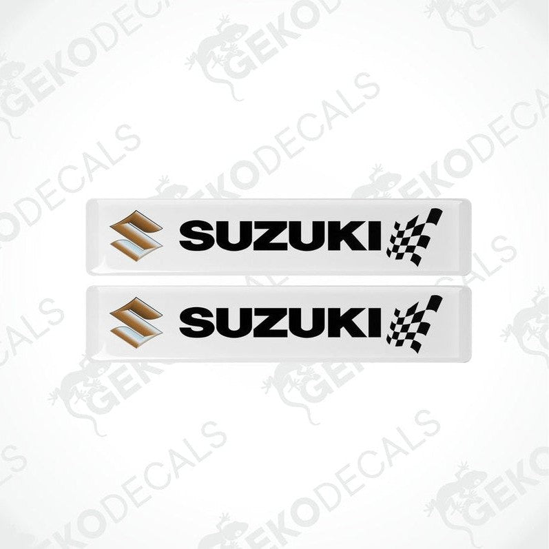 Two white rectangular vinyl decals with the SUZUKI brand logo and checkered flag design.
