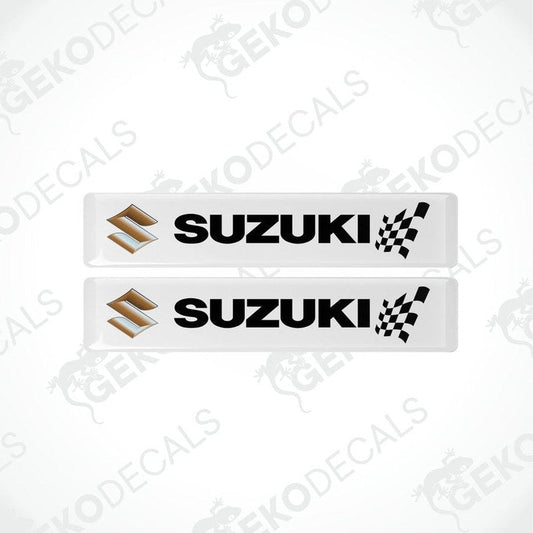 Two white rectangular vinyl decals with the SUZUKI brand logo and checkered flag design.