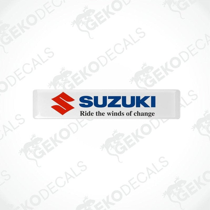 White rectangular vinyl decals with the SUZUKI logo and the phrase 'Ride the winds of change' printed on them.