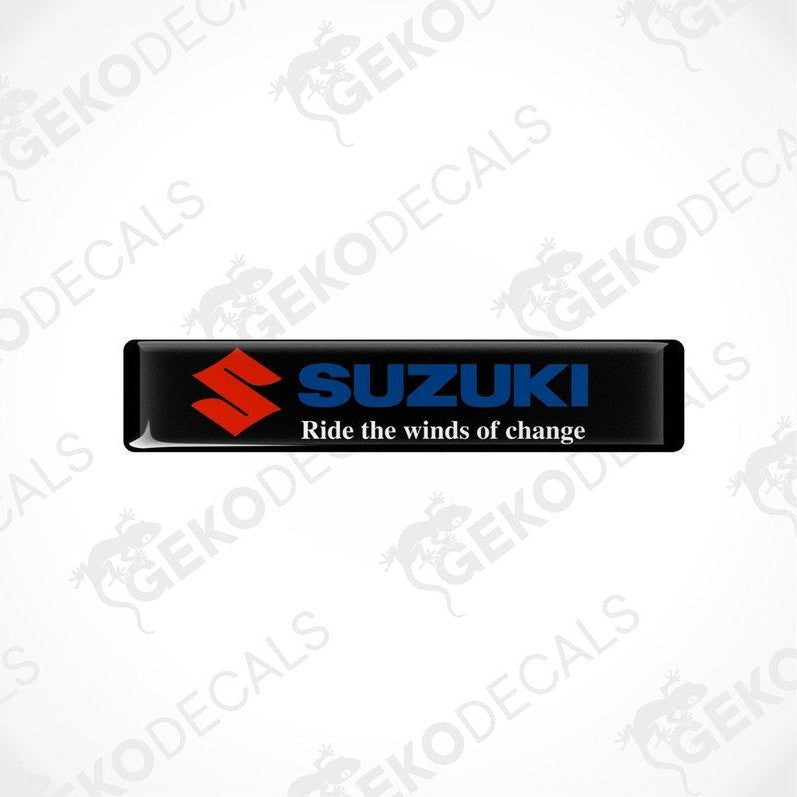 Black rectangular vinyl decals with the SUZUKI logo and the phrase 'Ride the winds of change' printed on them.