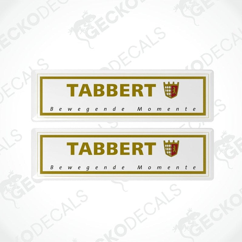 Two white vinyl stickers with the text 'Tabbert Beweegende Momente' and a coat of arms symbol, with a GeckoDecals watermark on the bottom right.