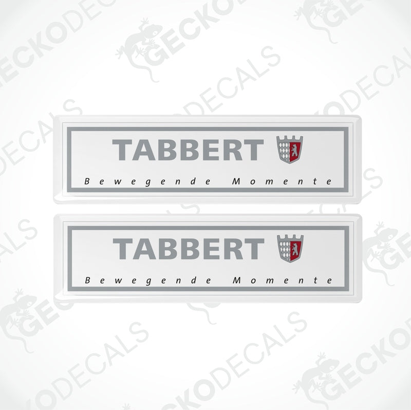 Two gray vinyl stickers with the text 'Tabbert Bewegende Momente' and the Tabbert logo, placed against a white background.