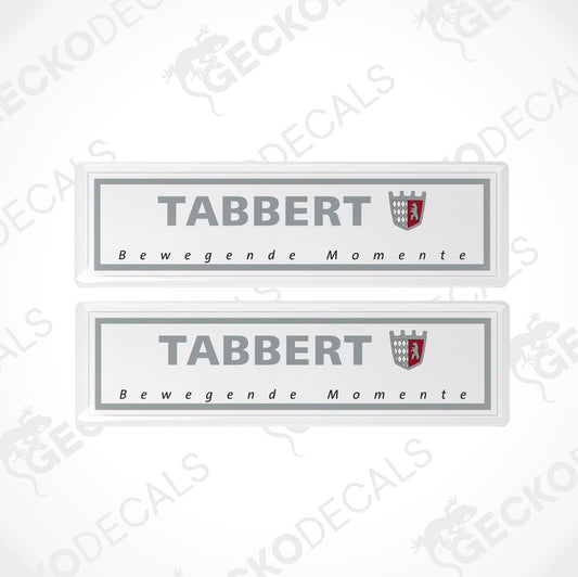 Two gray vinyl stickers with the text 'Tabbert Bewegende Momente' and the Tabbert logo, placed against a white background.