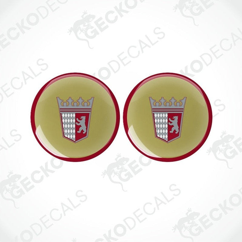 Two round vinyl stickers with a geometric pattern, consisting of a red and white emblem on a beige background, surrounded by a red border.