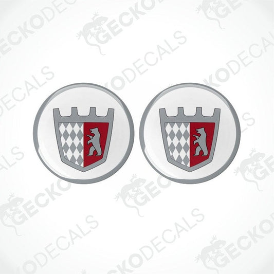 Two round vinyl stickers with a geometric pattern and a castle motif in red, white, and black colors on a transparent background.