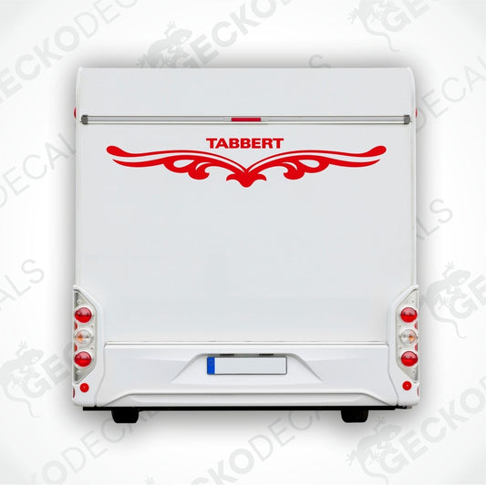 A white caravan with a red and black 'Tabbert' brand decal on the back door.