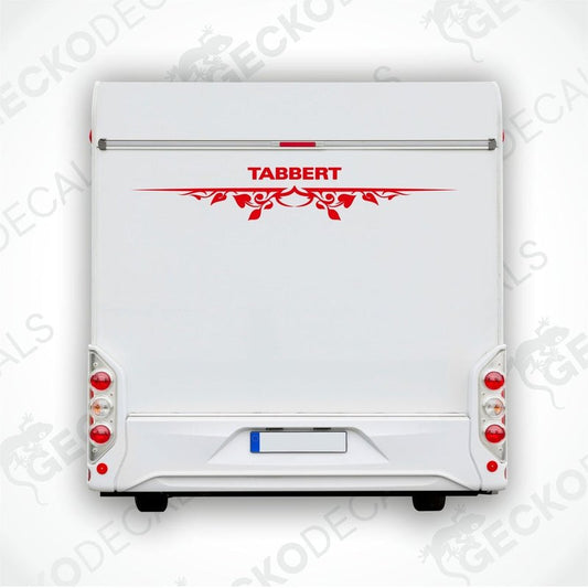 A white caravan with a red and black 'Tabbert' brand decal on the back door.