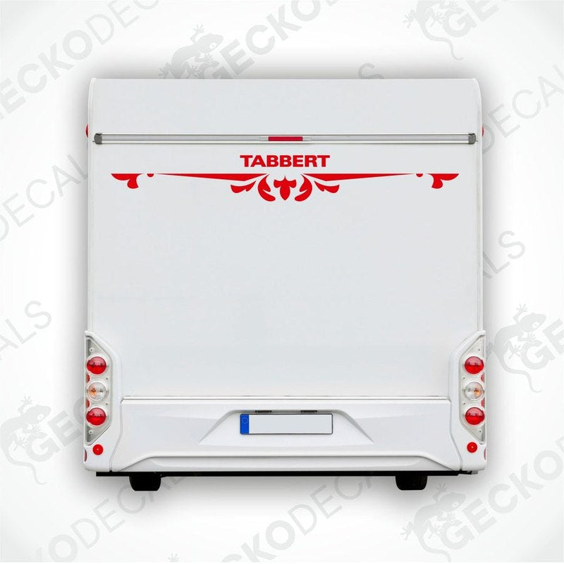A white caravan with a red and black Tabbert sticker on the back door.