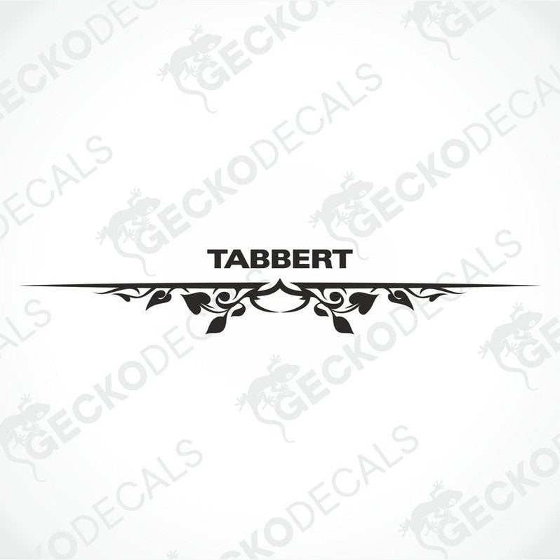 A white caravan with a red and black 'Tabbert' brand decal on the back door.