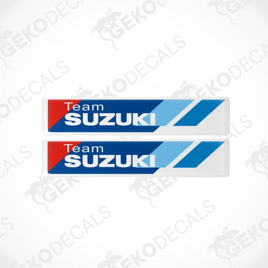Two blue, white, and red vinyl stickers with 'TEAM SUZUKI' text and Suzuki logo.