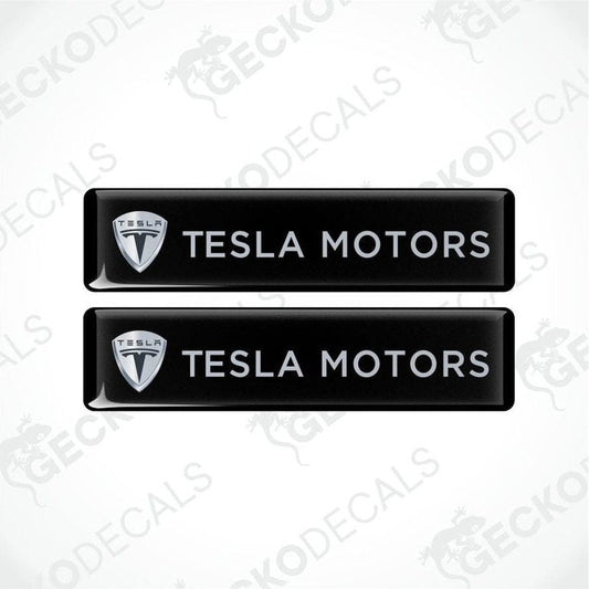 Two black Tesla Motors decals on a white background