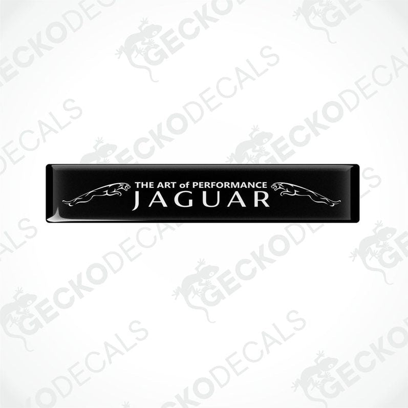  Rectangular black car decals with white text that reads 'THE ART OF PERFORMANCE JAGUAR'.