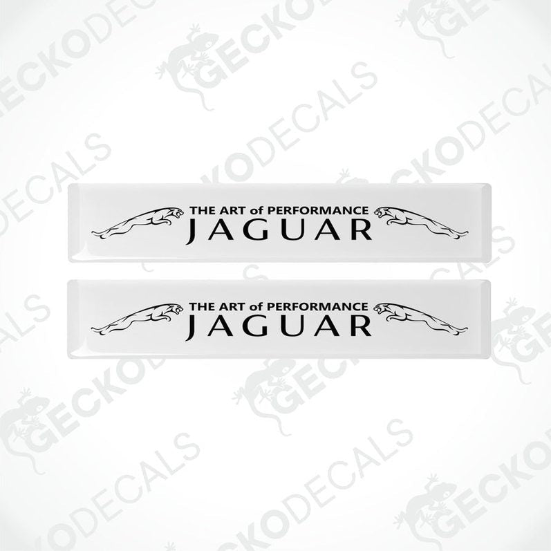 Two rectangular white car decals with black text that reads 'THE ART OF PERFORMANCE JAGUAR'.