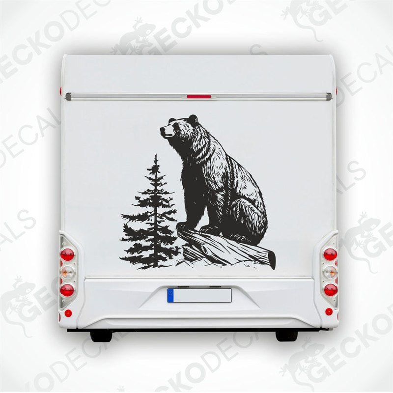 A die cut decal of a bear sitting on a stump, intended for use on vehicles or other surfaces, delivered on transfer paper.