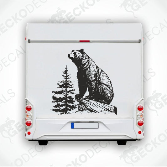 A die cut decal of a bear sitting on a stump, intended for use on vehicles or other surfaces, delivered on transfer paper.