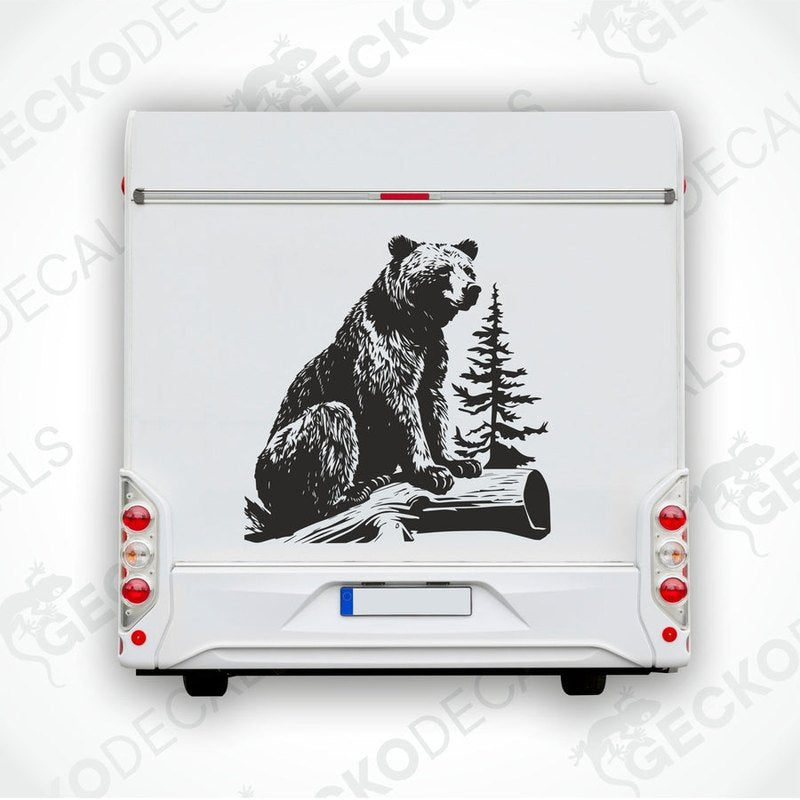A die cut sticker of a bear sitting on a stump, intended for use as a car decal or sticker.