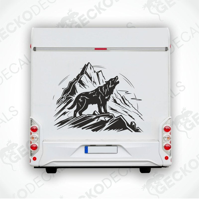 A decal of a wolf howling in a mountainous landscape, delivered on transfer paper.