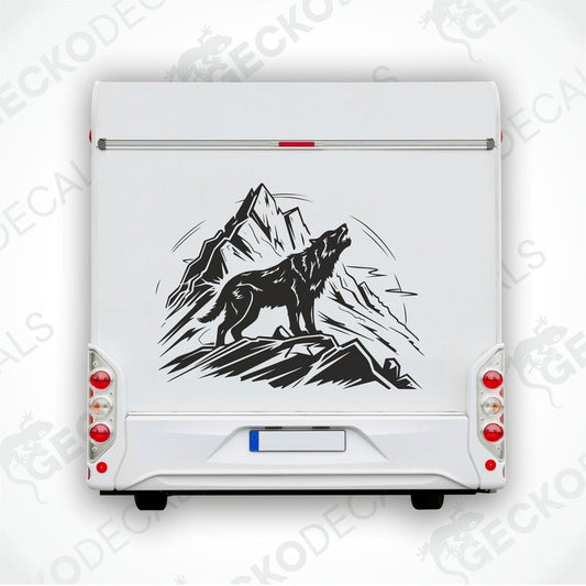 A decal of a wolf howling in a mountainous landscape, delivered on transfer paper.
