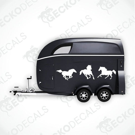 A black trailer with a die cut decal featuring three horses on the side.