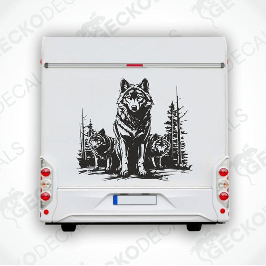 A black decal of three wolves in a forest setting, positioned on the rear of a white vehicle.