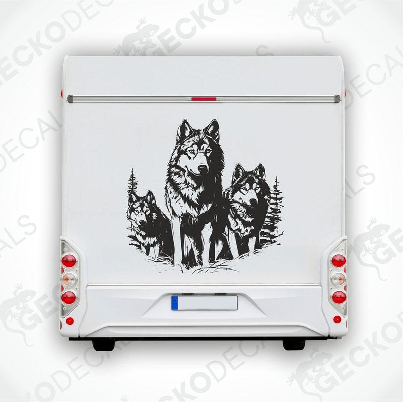 A black decal of three wolves walking in the forest, positioned on the rear of a white vehicle.