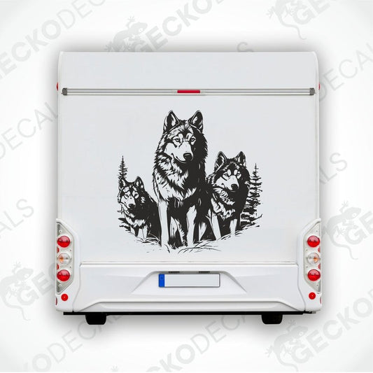 A black decal of three wolves walking in the forest, positioned on the rear of a white vehicle.