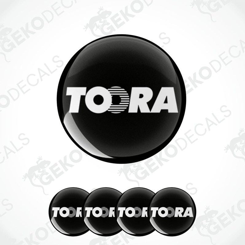 A set of black vinyl decals with the brand name TOORA, displayed in a circular arrangement with one large decal and four smaller ones.