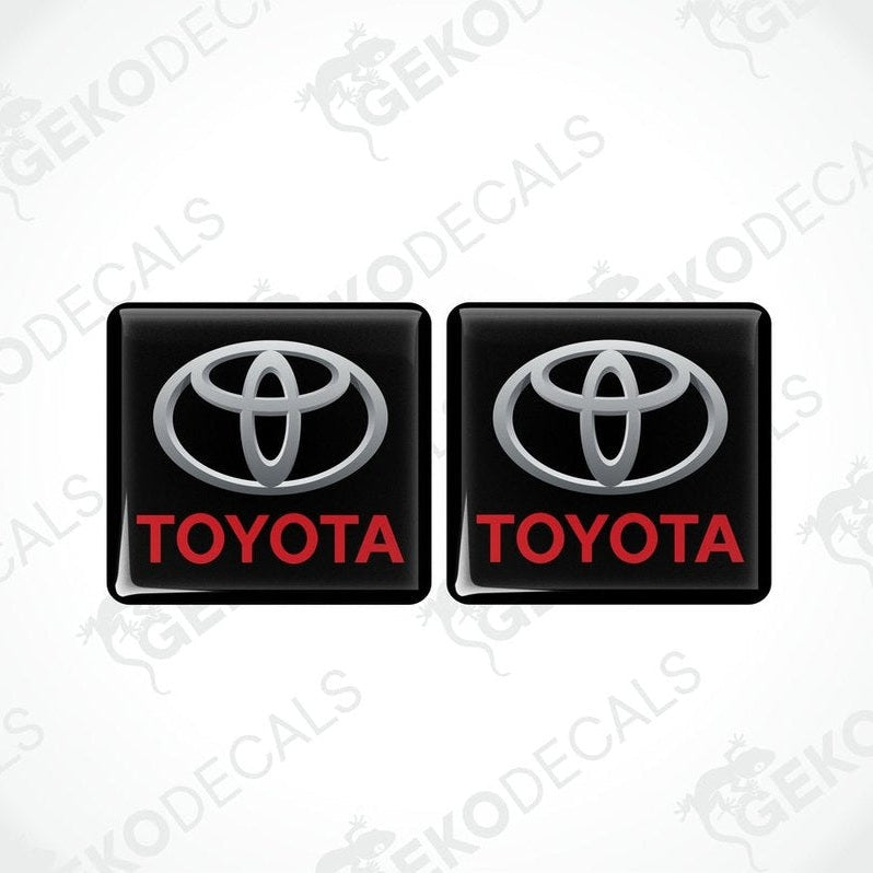 Two black vinyl stickers with the Toyota logo in red and white.
