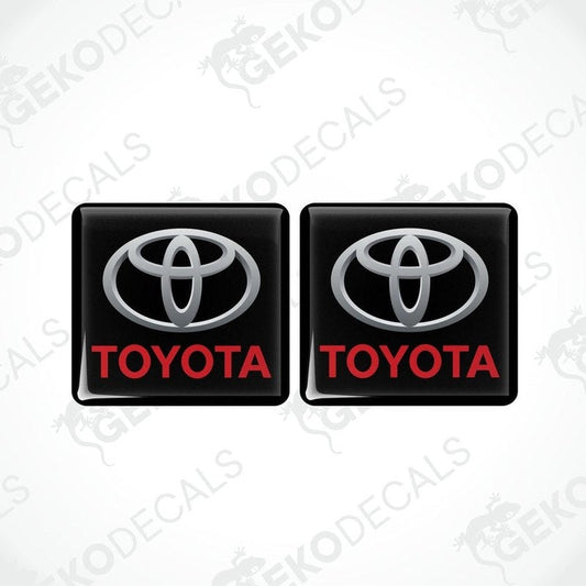 Two black vinyl stickers with the Toyota logo in red and white.
