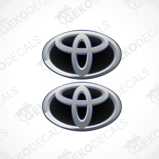 Two blue and silver Toyota branded vinyl stickers with a dome shape and a polyurethane coating.