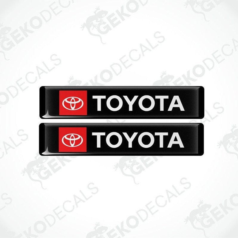 Two black vinyl stickers with the Toyota logo in red and white.
