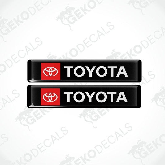 Two black vinyl stickers with the Toyota logo in red and white.