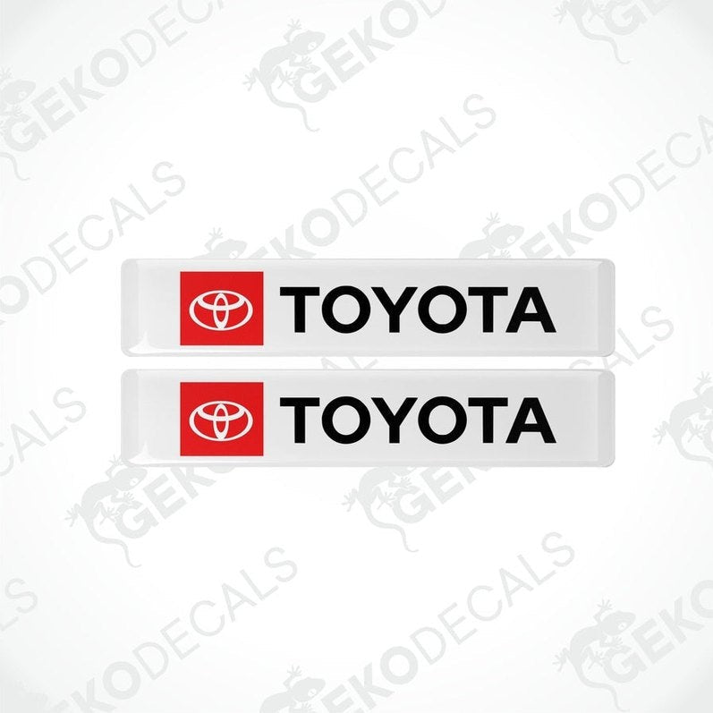 Two withe vinyl stickers with the Toyota logo in red and black.
