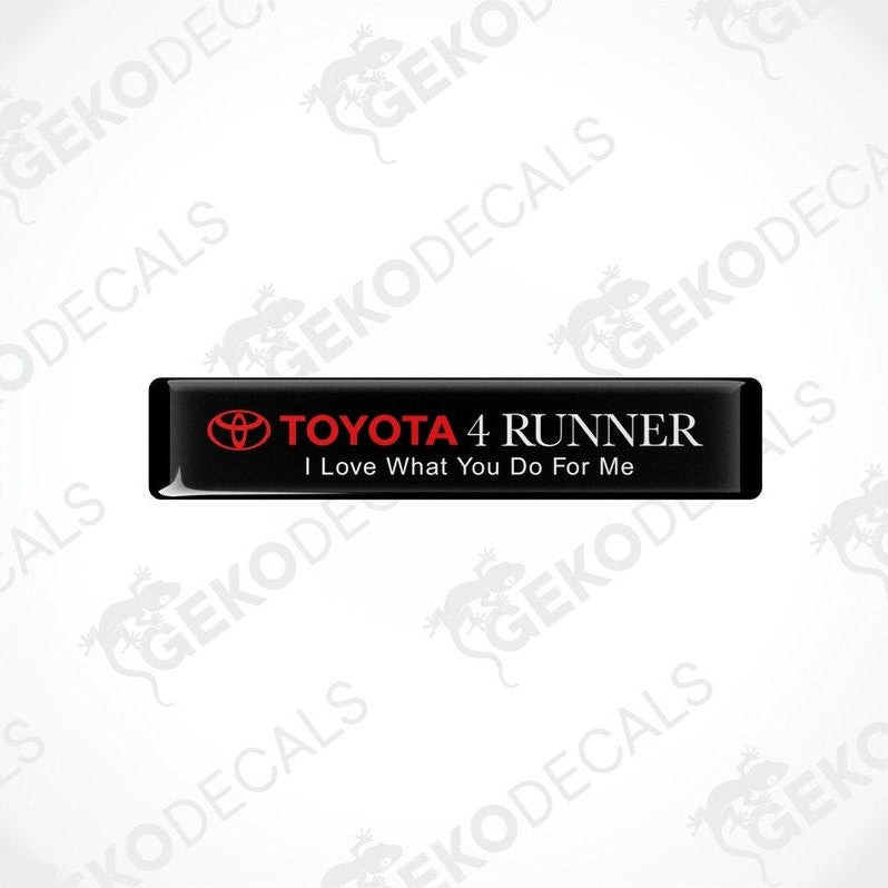 Black rectangular car decals with white text, one saying 'TOYOTA 4 RUNNER' and the other with the phrase 'I Love What You Do For Me'.