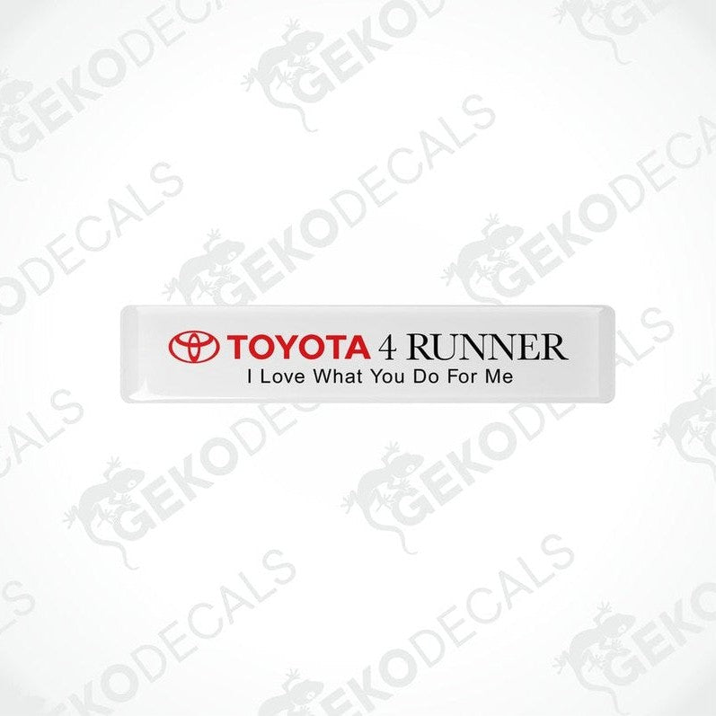  Withe rectangular car decals with blacktext, one saying 'TOYOTA 4 RUNNER' and the other with the phrase 'I Love What You Do For Me'.