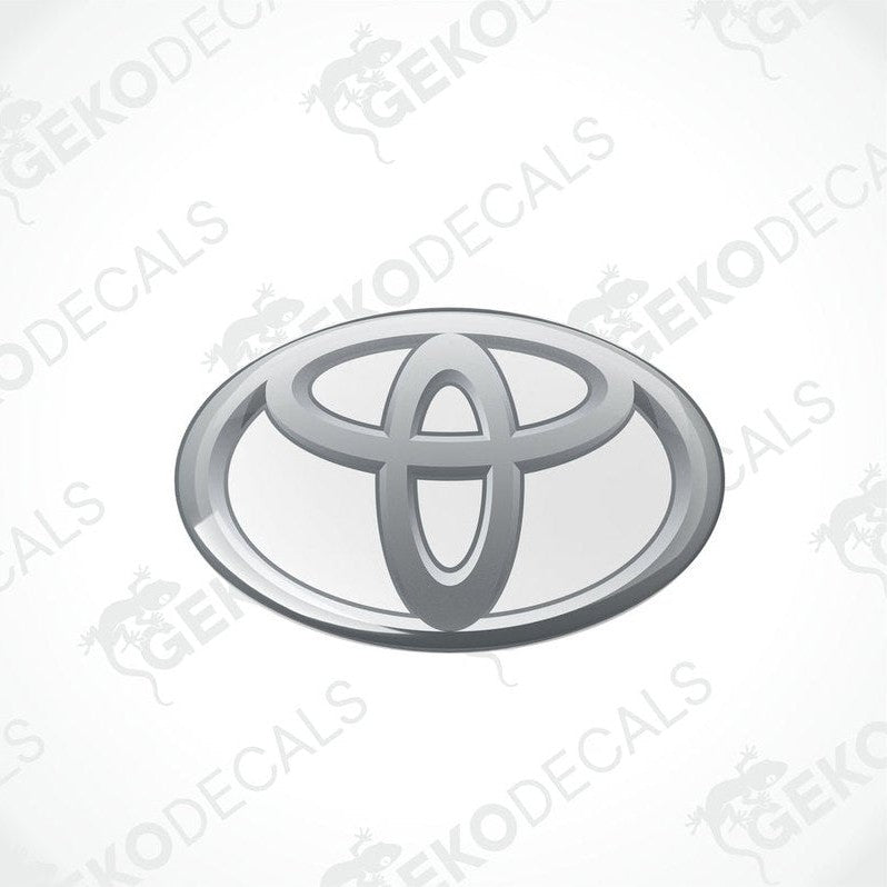 Toyota branded vinyl stickers with a dome shape and a silver and withe color scheme.